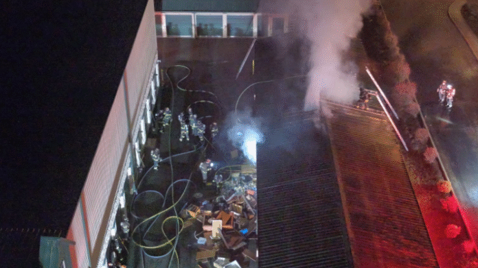 Everett firefighters use saws to cut into storage units and extinguish flames