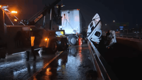 VIDEO: Trucker rescued after I-5 big-rig crash ended with cab dangling 7 stories above river in Oceanside